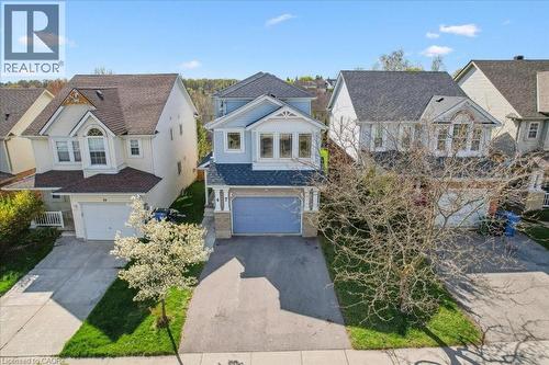 View of front of home with a residential view, asphalt driveway, and an attached garage - 47 Mccurdy Road, Guelph, ON 