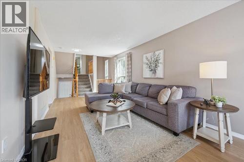 Living area featuring light wood-style flooring and stairs - 47 Mccurdy Road, Guelph, ON 