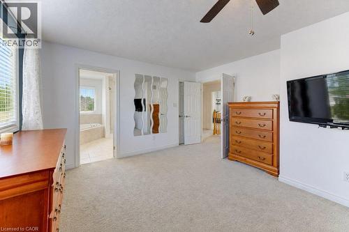 Plush carpeting throughout, white painted walls, and a ceiling fan with integrated lighting - 88 Decaro Crescent, Cambridge, ON 