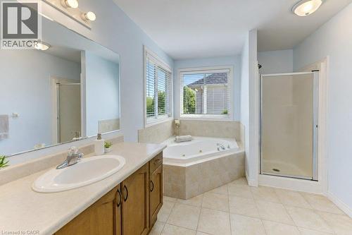 Double vanity with integrated sink, chrome faucet, and wood-finish cabinetry - 88 Decaro Crescent, Cambridge, ON 