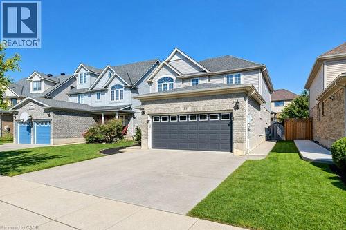 Two-story residence featuring light gray siding, a dark gray garage door, and a light-colored brick facade - 88 Decaro Crescent, Cambridge, ON 
