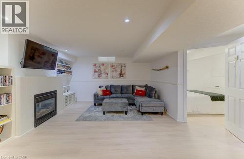 Recessed lighting, wood-finish flooring, and a built-in fireplace - 88 Decaro Crescent, Cambridge, ON 