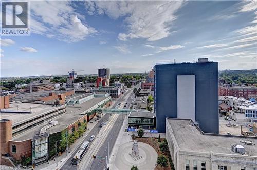 Urban landscape featuring multiple high-rise buildings, a multi-story parking structure, and a central thoroughfare - 60 Frederick Street Unit# 1213, Kitchener, ON 