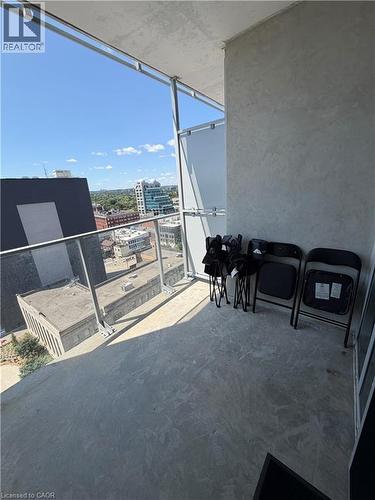 Balcony featuring a concrete floor, glass railing, and urban landscape - 60 Frederick Street Unit# 1213, Kitchener, ON 