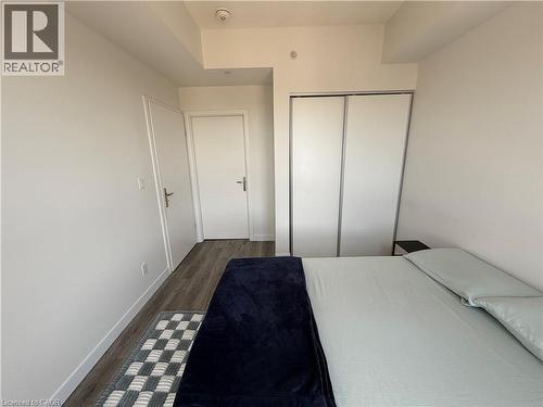 Wood-finish flooring, white walls, and white doors - 60 Frederick Street Unit# 1213, Kitchener, ON 