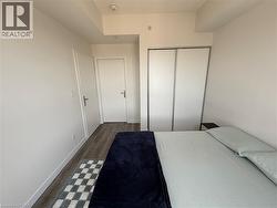 Wood-finish flooring, white walls, and white doors - 