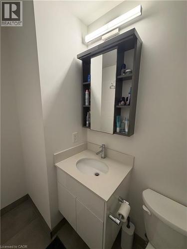 Light-toned vanity with an integrated sink and chrome faucet - 60 Frederick Street Unit# 1213, Kitchener, ON 
