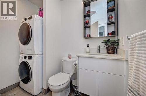 White vanity with a light-toned countertop, a rectangular sink, and a wall-mounted faucet - 60 Frederick Street Unit# 1213, Kitchener, ON 