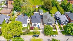 Detached residential property with a white exterior and a dark roof, featuring a vibrant blue front door - 