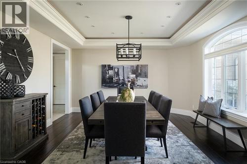 Dark wood-finish flooring, tray ceiling with recessed lighting, crown molding, and an arched window - 1505 Milburough Line, Carlisle, ON 