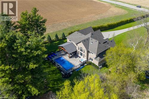 Expansive property with a multi-level roofline, extensive paved driveway, and established landscaping - 1505 Milburough Line, Carlisle, ON 