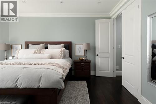 Dark wood-finish flooring, recessed ceiling lighting, crown molding, and paneled doors - 1505 Milburough Line, Carlisle, ON 