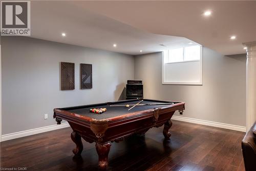 Recessed lighting illuminating a spacious room with dark wood-finish flooring and light-toned walls - 1505 Milburough Line, Carlisle, ON 