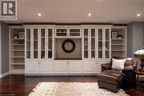 Custom built-in cabinetry with glass-front uppers, open shelving, and integrated recessed lighting - 1505 Milburough Line, Carlisle, ON 