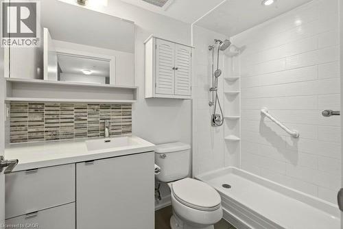 Modern bathroom featuring a walk-in shower with white subway tile, an integrated shower system, and built-in shelving - 457 Plains Road Unit# 225, Burlington, ON 