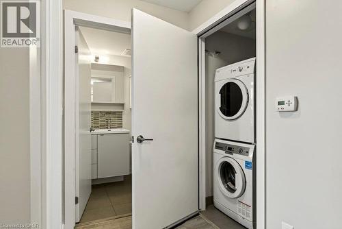 Integrated laundry closet featuring a stacked washer and dryer - 457 Plains Road Unit# 225, Burlington, ON 