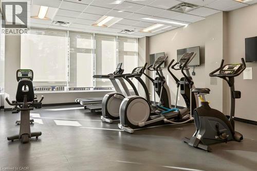 Fitness center with multiple cardio machines, television screens, recessed lighting, and large windows with roller shades - 457 Plains Road Unit# 225, Burlington, ON 