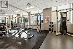 Dedicated fitness center featuring rubber flooring and mirrored walls - 