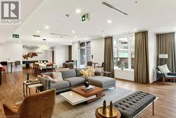 Open-concept common area featuring wood-finish flooring, recessed lighting, and large windows - 