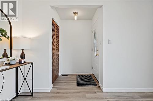 Lovely updated steel front door welcomes you home! Bright entry features NEW vinyl flooring, NEW light fixture & opens to spacious living room. - 589 Mohawk Road W, Hamilton, ON 