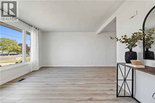 BRIGHT & INVITING living room with massive vinyl window adds natural light to this lovely open floor plan. - 589 Mohawk Road W, Hamilton, ON 
