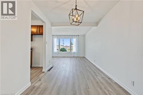 Dining room features a NEW dining room light, NEW vinyl flooring & has just been freshly painted!! - 589 Mohawk Road W, Hamilton, ON 