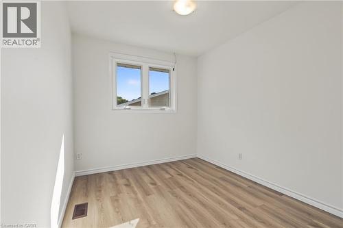 BEDROOM 3, closet, large vinyl window & NEW vinyl flooring. - 589 Mohawk Road W, Hamilton, ON 