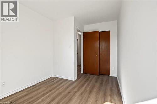 BEDROOM 3, closet, large vinyl window & NEW vinyl flooring. - 589 Mohawk Road W, Hamilton, ON 