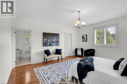 Spacious bedroom with wood-finish flooring and white walls - 302 German School Road, Paris, ON 