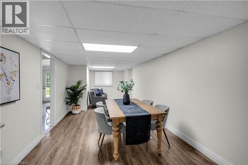 Spacious room featuring wood-finish flooring, crisp white walls, and a dropped ceiling with integrated lighting - 302 German School Road, Paris, ON 