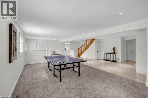 Spacious lower level featuring dual flooring types with plush carpeting and large format tile, recessed lighting, and a bright white color palette - 302 German School Road, Paris, ON 