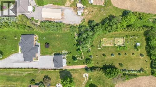 Expansive property featuring a multi-gabled main residence, a detached auxiliary building, and a large cultivated garden area - 302 German School Road, Paris, ON 