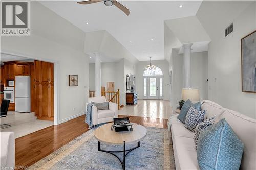 Spacious living area featuring high vaulted ceilings, recessed lighting, and wood-finish flooring - 302 German School Road, Paris, ON 