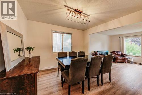 Open concept living space with wood-finish flooring, recessed lighting, and ample natural light - 143 Sunrise Place, Kitchener, ON 