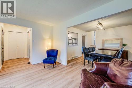 Wood-finish flooring throughout, white walls, and a recessed entryway with a white door - 143 Sunrise Place, Kitchener, ON 