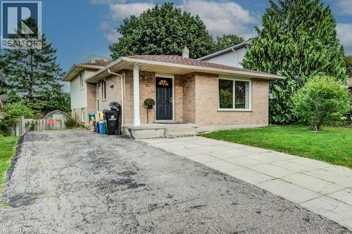 Brick exterior with a prominent entry door and side window - 143 Sunrise Place, Kitchener, ON 