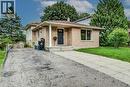 Brick exterior with a prominent entry door and side window - 143 Sunrise Place, Kitchener, ON 