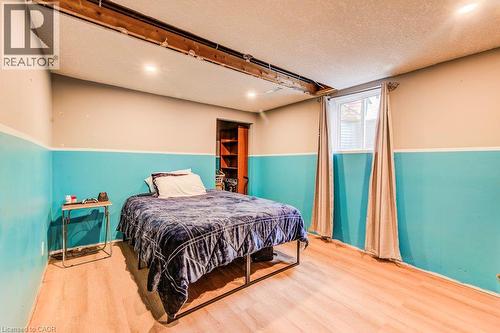 Wood-finish flooring with a single window and recessed lighting - 143 Sunrise Place, Kitchener, ON 