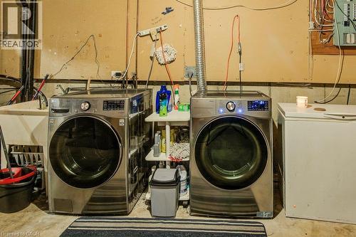 Dedicated laundry area featuring a utility sink and concrete flooring - 143 Sunrise Place, Kitchener, ON 