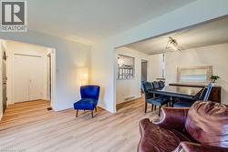 Wood-finish flooring throughout, white walls, and a recessed entryway with a white door - 