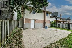Paved patio area with direct exterior access, brick and siding exterior, and a privacy fence - 