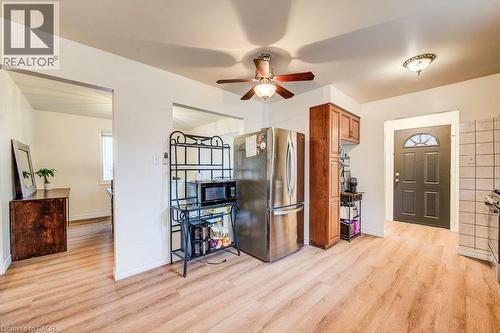 Wood-finish flooring throughout, complemented by a ceiling fan with integrated lighting - 143 Sunrise Place, Kitchener, ON 