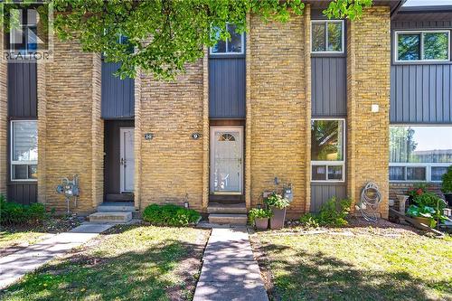 Multi-story facade featuring stacked stone and vertical siding - 1517 Elm Road Unit# 9, Oakville, ON 