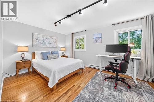 Hardwood flooring, track lighting, dual windows, light gray wall color, and a functional desk area - 1517 Elm Road Unit# 9, Oakville, ON 