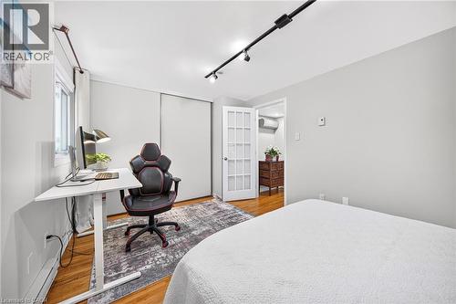 Hardwood flooring, track lighting, white trim, white walls, and a white French door - 1517 Elm Road Unit# 9, Oakville, ON 