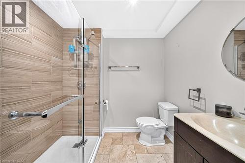 Glass-enclosed shower with horizontal tile surround and chrome fixtures - 1517 Elm Road Unit# 9, Oakville, ON 