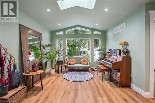 Vaulted ceiling with skylight, recessed lighting, carpet-free floor, and expansive windows - 58 Balmoral Avenue N, Hamilton, ON 