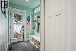 Bright mudroom entry featuring recessed lighting, closet, and dark slate tile flooring - 