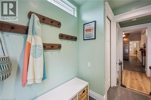 Bright mudroom featuring a transom window, wood-finish wall-mounted hooks, and a closet for storage - 58 Balmoral Avenue N, Hamilton, ON 