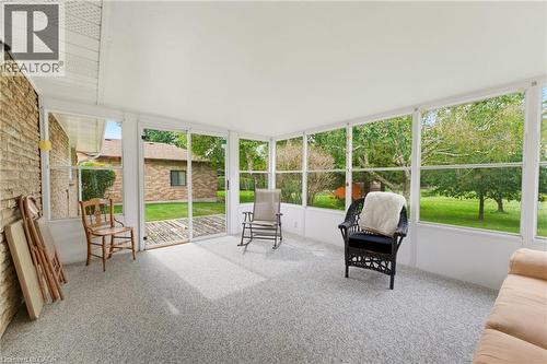 Enclosed sunroom with expansive windows, offering abundant natural light and exterior access - 15 Mclaren Avenue N, Listowel, ON 